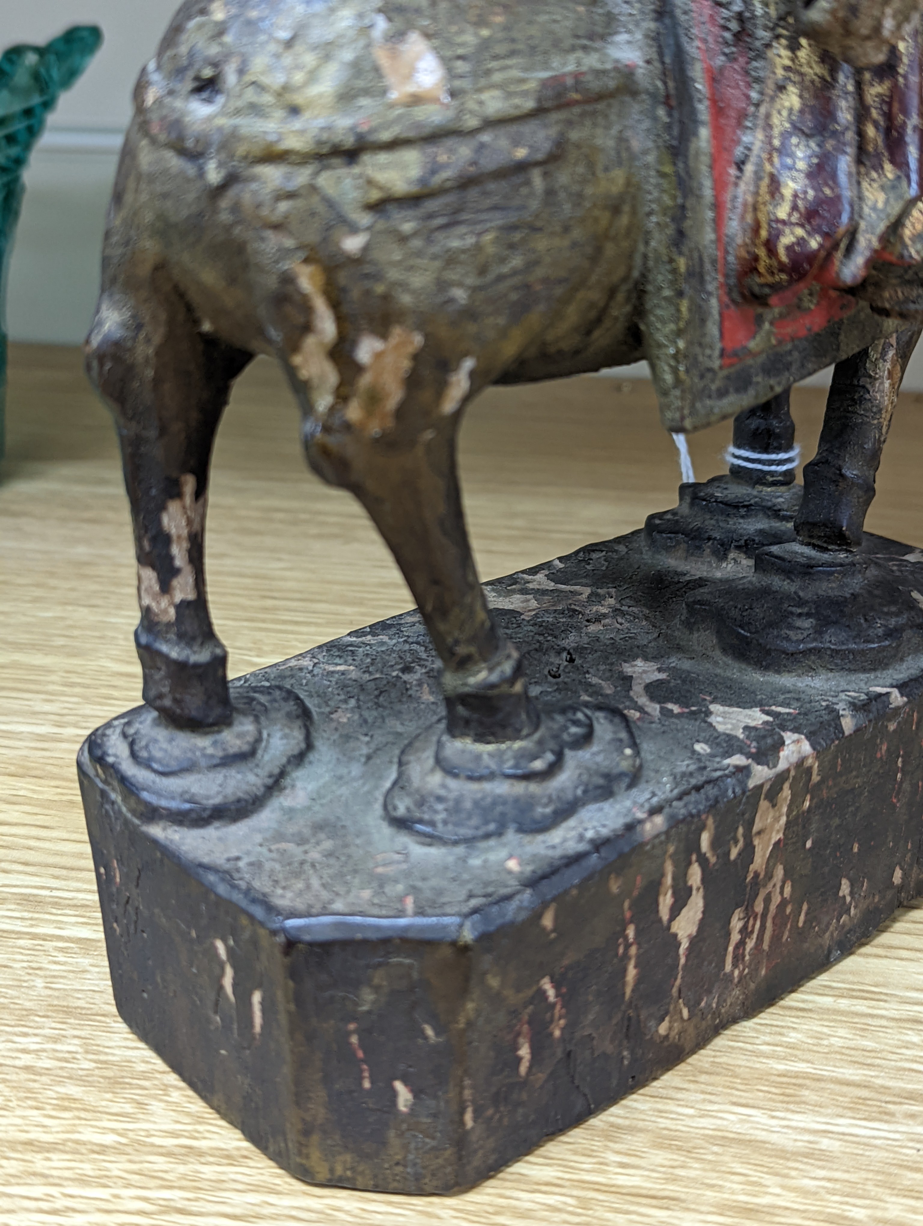 An 18th/19th century Chinese lacquered wood group of an official riding a horse, 30cm